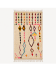 Tapis Beni Ouarain artisanal marocain en laine ivoire crème à motifs berbères multicolores