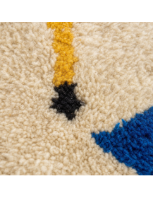 Gros plan sur la texture dense et moelleuse de la laine, les fibres irrégulières et les motifs multicolores