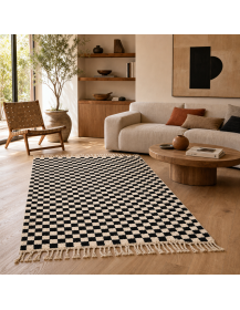 Tapis Beni Ouarain noir et ivoire dans un intérieur contemporain aux matières naturelles