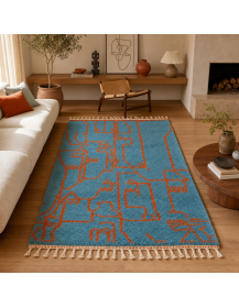 Tapis marocain artisanal turquoise et orange rouille dans un intérieur contemporain chaleureux