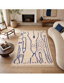 Tapis artisanal marocain en laine ivoire écru et bleu profond dans un intérieur contemporain