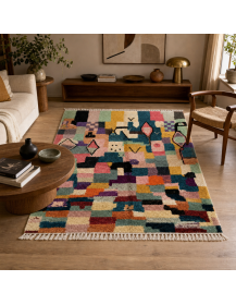 Tapis artisanal marocain en laine vert sauge, bleu pétrole et rose poudré dans un intérieur contemporain éclectique